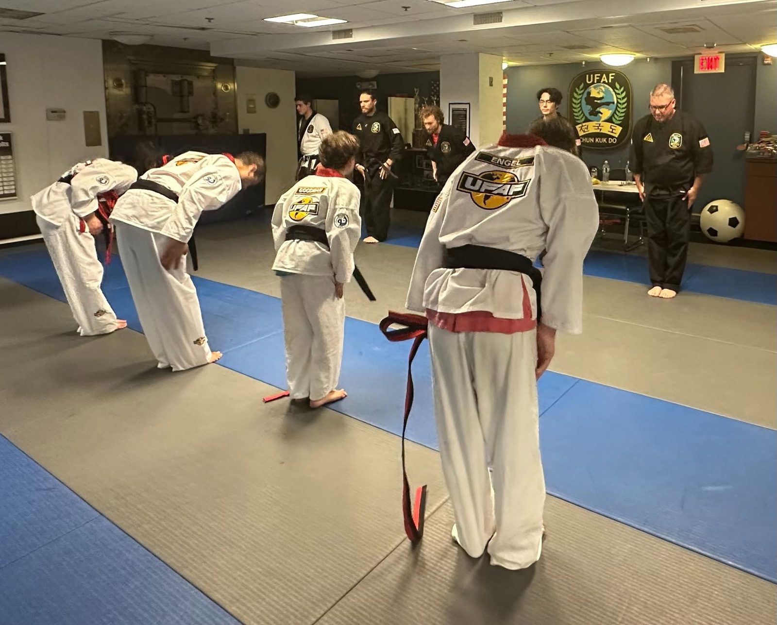 Kids bowing in to start a class at Giroux Bros