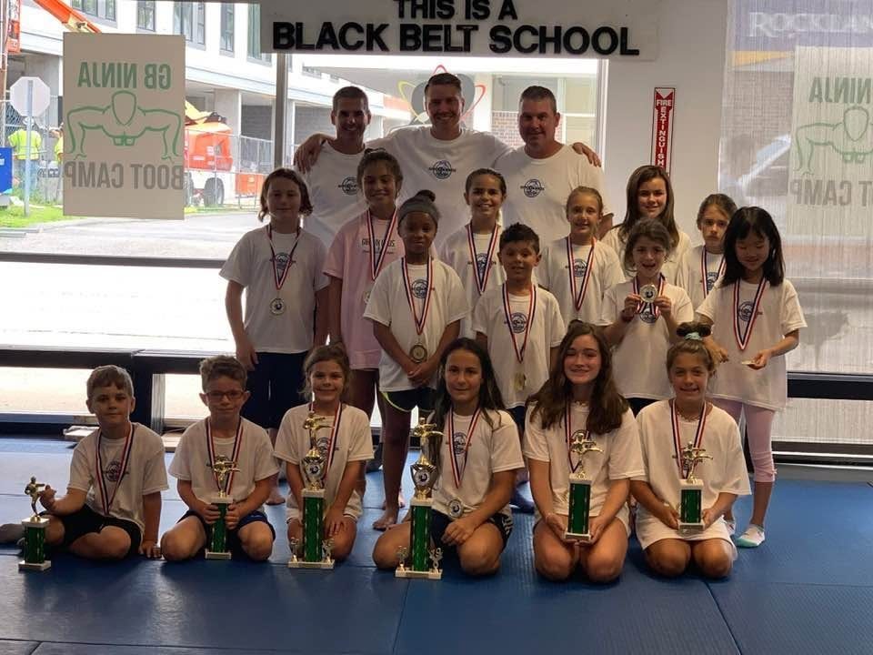 Young Giroux Bros students with their tournament medals and trophies