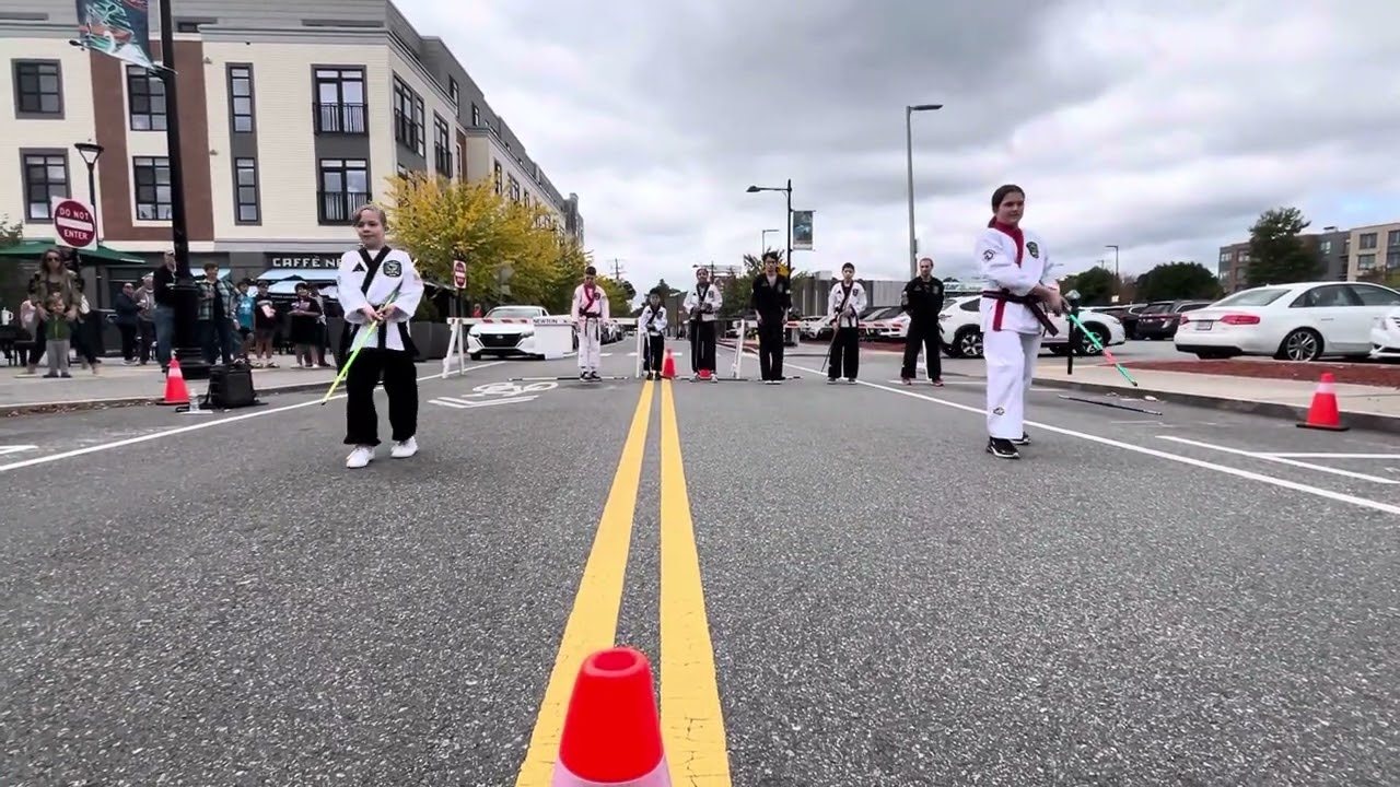 Giroux Bros students performing a karate demo on the street at the Newtonville Fair